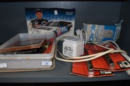 Two unused personal alarms, an extension lead and a box of circular saw blades.