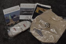 A collection of Cunnard memorabilia including books and more.