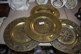 Four various late 19th century brass plaques of Chinese design having pictorial decoration and