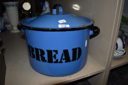 A vintage blue enamel bread bin having black lettering.