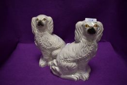 A pair of Staffordshire flat back mantel or fireside dogs.
