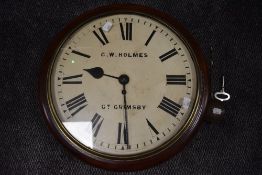 A large early 19th century mahogany cased C.W Holmes wall mounted station/municipal building clock,