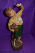 An early 20th Century plaster figure modelled as fruit picking boy (Cherry boy) , some damage and