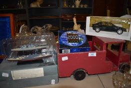 A wooden truck, a boxed model BMW 325i and a millennium clock.