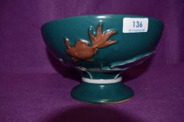 A large blue fruit bowl or similar having debossed floral design with fish.