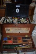 A vintage mahogany boxed Reeves and Woodyer paint set,a similar tin of paints and a palette.