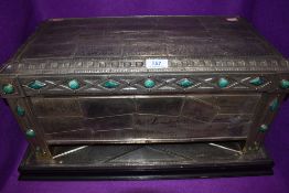 A 1930s table top casket having individual pewter panels, and green hard stone decorative detailing,