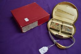 A vintage metal evening bag in box,with two internal matching compacts, comb, purse and two pockets,