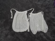 A small selection of antique table linen, pillow case and two aprons, all with intricate