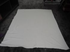 An antique early 20th century Marseilles bed throw of coverlet, white on white with ornate floral,