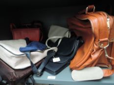 A collection of handbags, a lot leather and some still having tags attached also a vintage tan