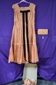 A stunning vintage 1950s dress in apricot lace with matching clutch bag.fully lined with an