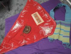 A red Victorian Fichu with white embroidery, a purple velvet drawstring bag with filigree thread