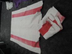 Two large early 20th century quilts, both of cotton in red, pink and whites predominantly.wear