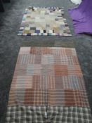 Two vintage quilts, mostly made up of square and rectangular sections of wool and backed in cotton,a