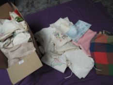 A box full of vintage table linen and similar including embroidered pieces, crotchet work and more.