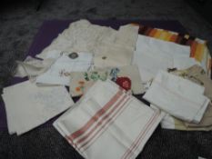 A selection of vintage table cloths,huckaback towels, mats and more,included are embroidered items