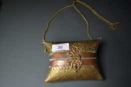 An ornate vintage brass and copper embossed evening bag or similar.having clasp fastening to front