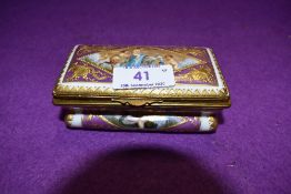 A hard paste continental trinket box hand decorated with mythical cherub and sea beast
