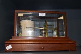 An early 20th century barograph having bevel edged glass and mahogany case with brass fitments