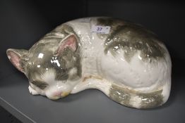 A ceramic figure of a tabby cat possibly by Cappo De Monte signed Italy to base (chips to ears)
