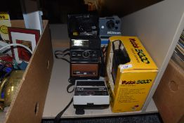 A selection of various Polaroid or Instant cameras, including Kodak EK200, EK300, EK4, Polaroid