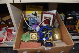 A selection of curios and trinkets including clock and calculator