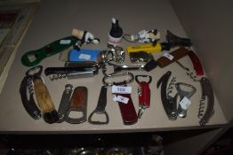 An assortment of vintage and collectable bottle openers, cork screws and bottle stoppers.