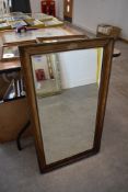 A mantle mirror having bevel edged glass with gilt and plaster frame