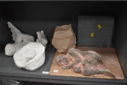 A selection of studio artworks including nude ceramic figure