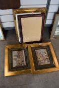 An assortment of prints and ornate frames.