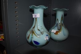 Two coloured glass vases with mottled blue and orange swirls