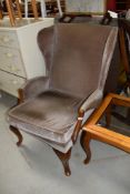 A vintage Parker Knoll wing back armchair
