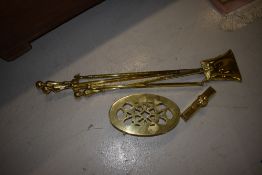 A selection of polished brass fire tools, including footman