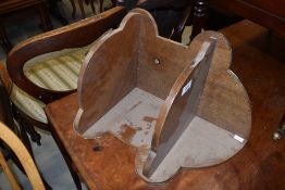 A mid 20th Century oak corner wall shelf of small proportions