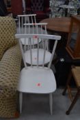 A set of three vintage painted kitchen chairs having rail and stick backs, in the Ercol style