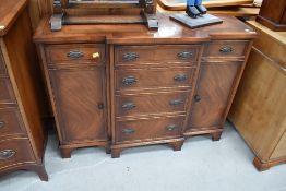 A Reprodux reproduction yew wood breakfront sideboard of small proportions, width approx. 104cm