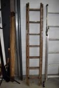 A set of vintage wooden extending ladders