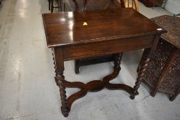 An early 20th Century oak side table having twist legs and 'X' frame, width approx. 76cm