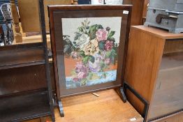 An early 20th Century stained frame embroidered fire screen