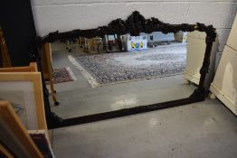 A large hardwood overmantel mirror, foliate decoration with couple of chips off, width approx.150cm