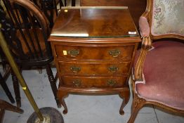 An early 20th Century walnut three drawer bedside chest, width approx. 45cm