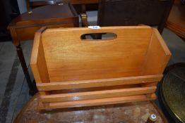 A rustic light stained magazine rack