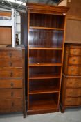 A reproduction yew wood book case, approx 66cm wide, height 185cm
