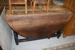 A 19th Century oak gateleg table, top sun bleached and few coffee marks etc, width approx. 130cm