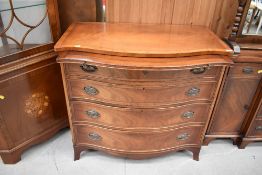 A Reprodux reproduction yew wood serpentine front chest of four drawers, and brushing slide, width
