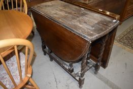 An early to mid 20th Century oak part stripped twist gate leg table