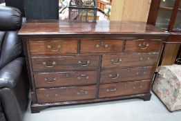 An early 19th century mahogany Lancashire style mule chest having lift lid with front dummy and four