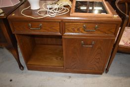 A mid to late 20th Century oak hifi or similar sideboard, having half cupboard and half shelved