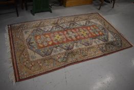 An Oriental style rug, approx 210 x 120cm